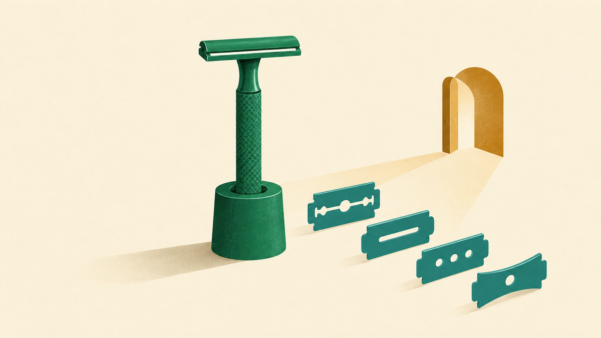 A metal razor holder beside interchangeable blade shapes and an open supply route.